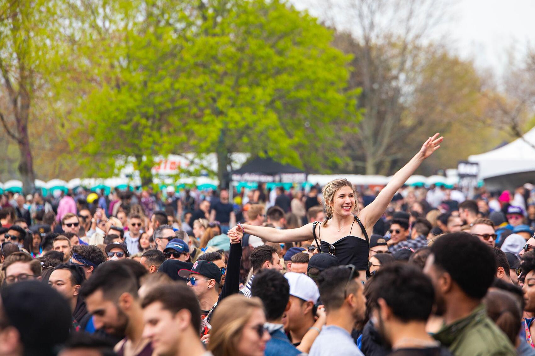A dense outdoor festival crowd in daylight